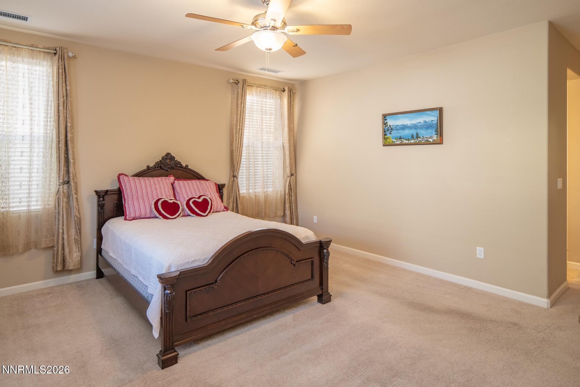 1413 Bluewood Drive Reno, NV 89523 - Photo 19 of 42 a bedroom with a bed and a chandelier