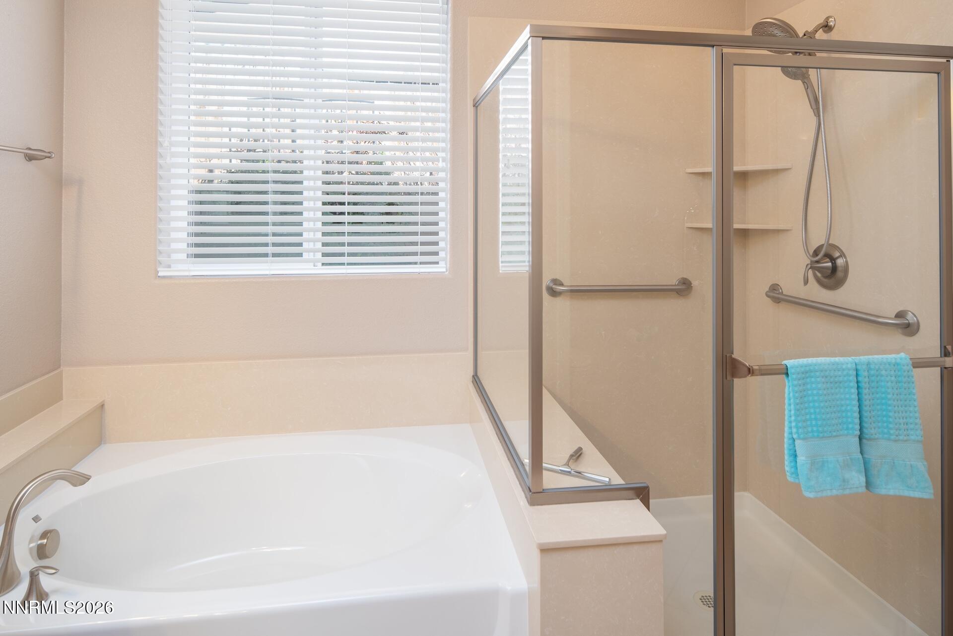 1413 Bluewood Drive Reno, NV 89523 - Photo 21 of 42 a bathroom with a bathtub and a shower