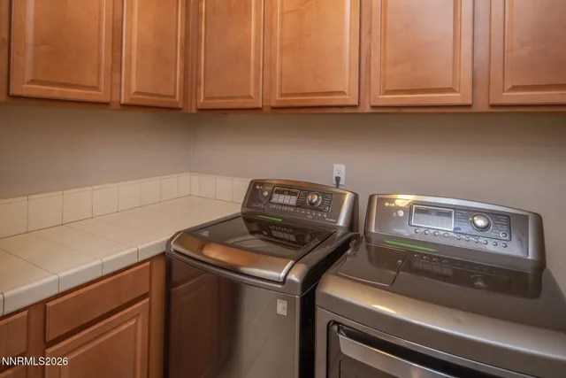 a aerial view of a house with a big yard plants and large tree