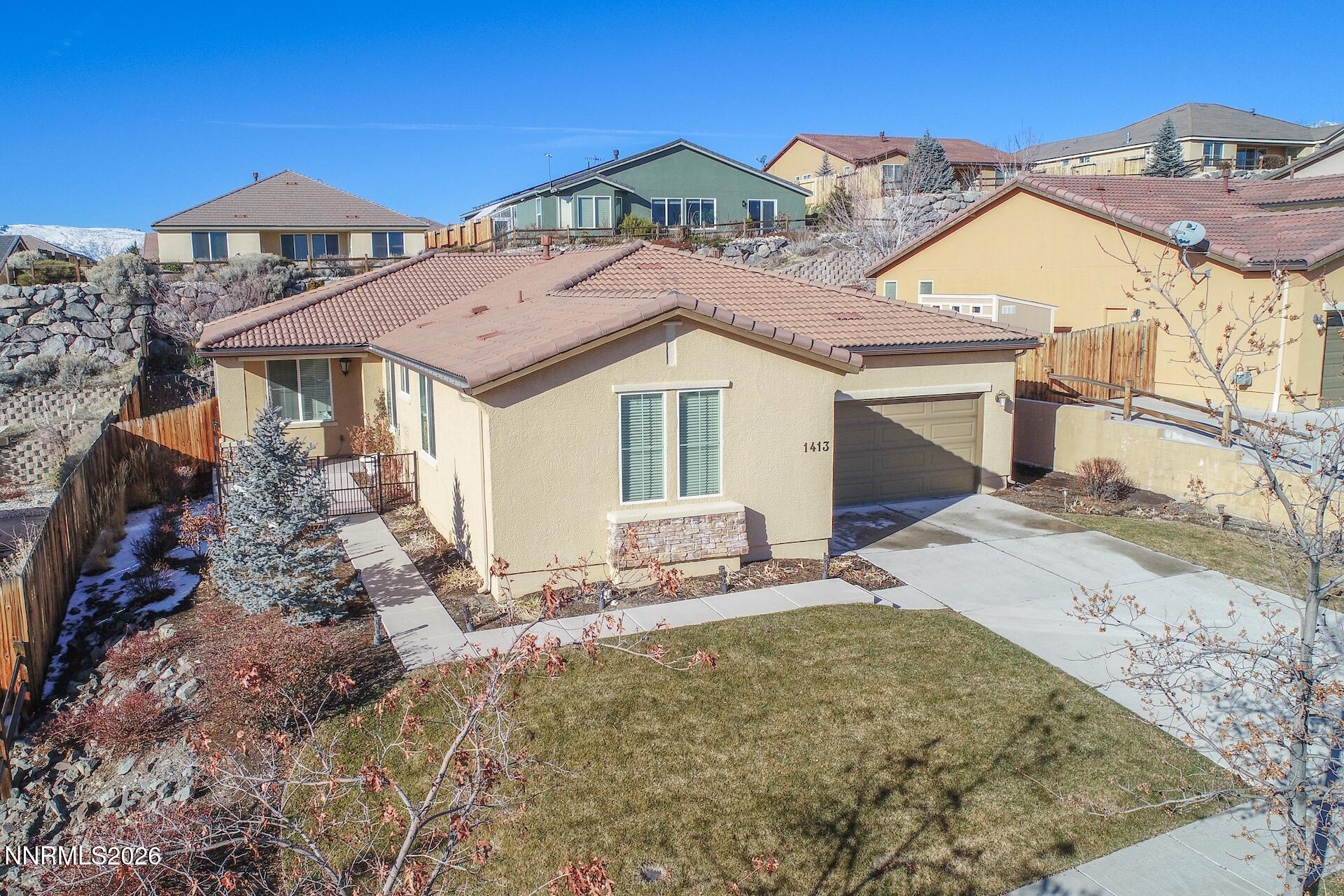1413 Bluewood Drive Reno, NV 89523 - Photo 5 of 42 a front view of a house with a yard