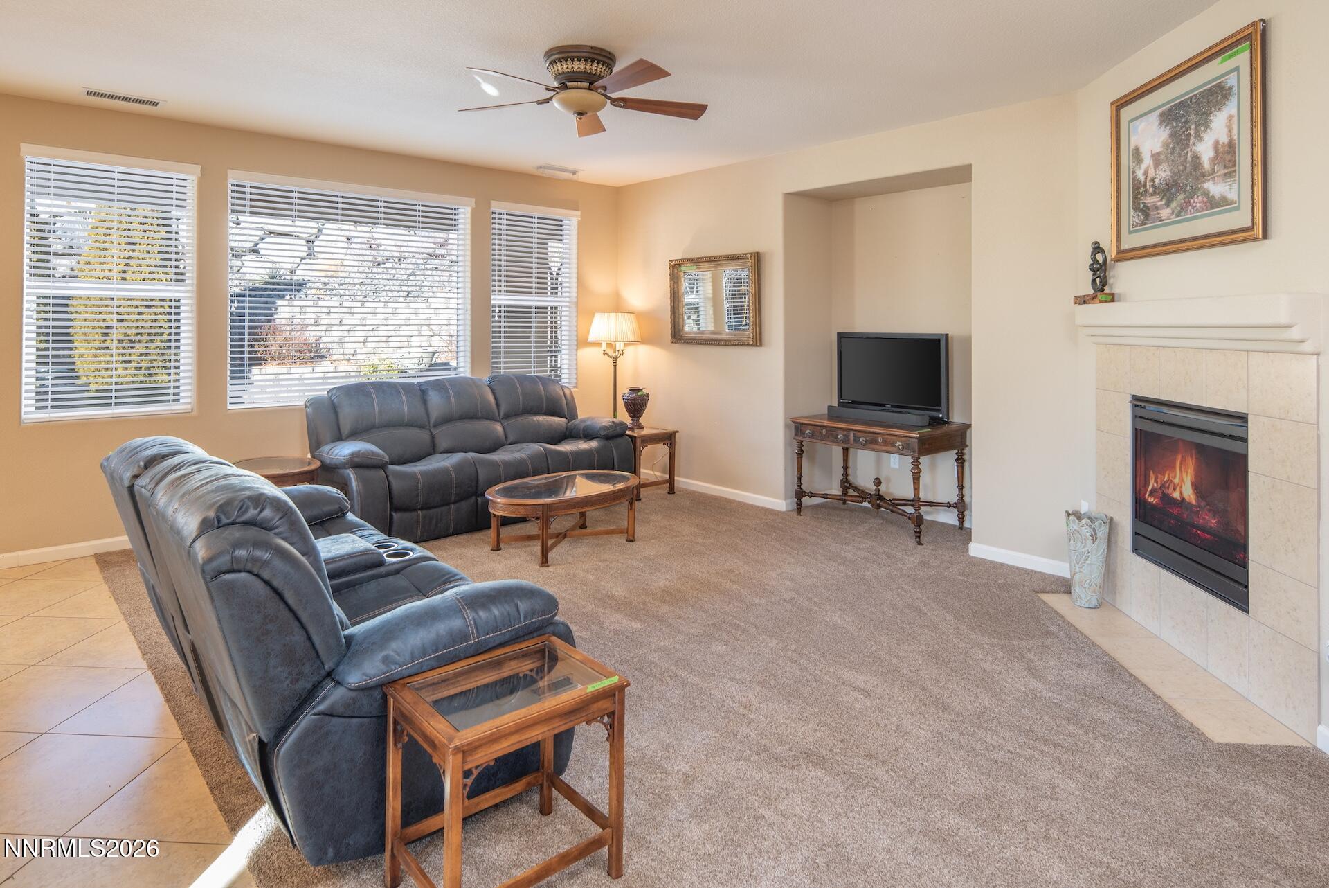 1413 Bluewood Drive Reno, NV 89523 - Photo 10 of 42 a living room with furniture a fireplace and a flat screen tv