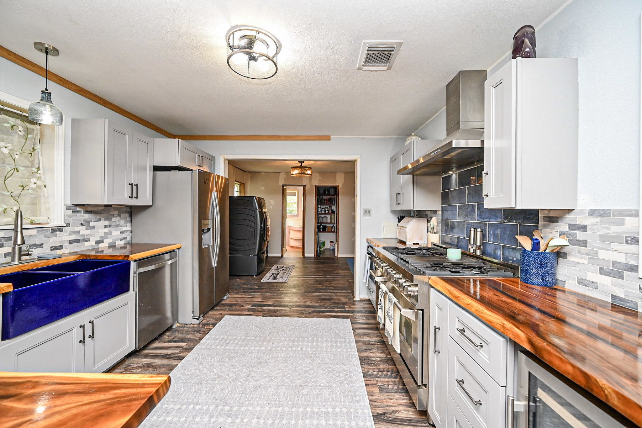 14920 Bj Dusek Road Wallis, TX 77485 - Photo 4 of 20 a kitchen with granite countertop a sink a counter top space stainless steel appliances and cabinets
