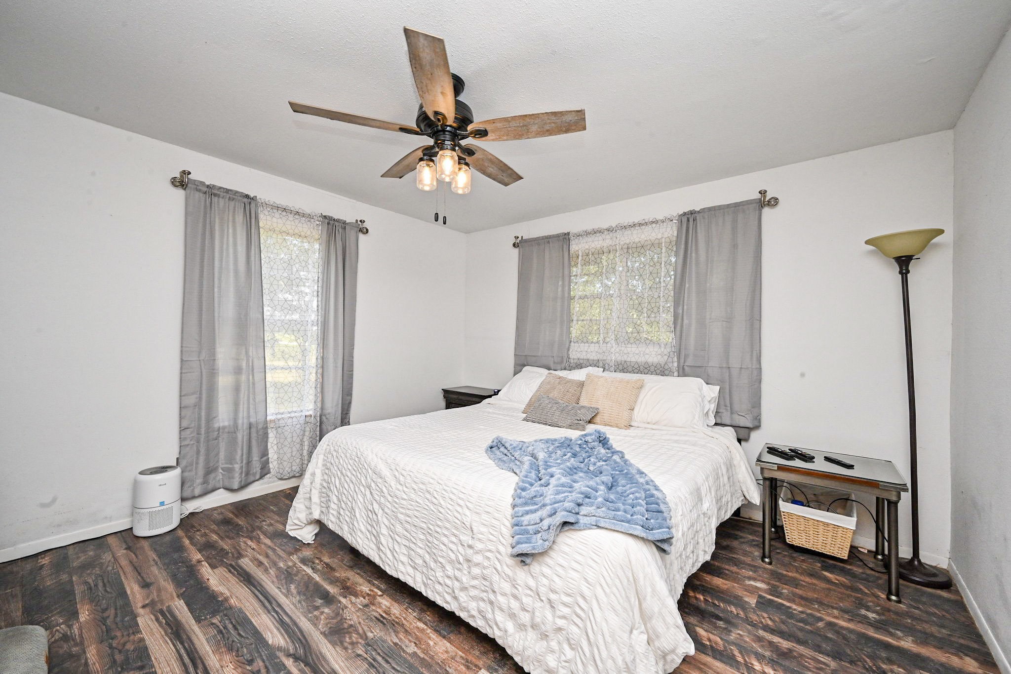 14920 Bj Dusek Road Wallis, TX 77485 - Photo 10 of 20 a bedroom with a large bed and a chandelier