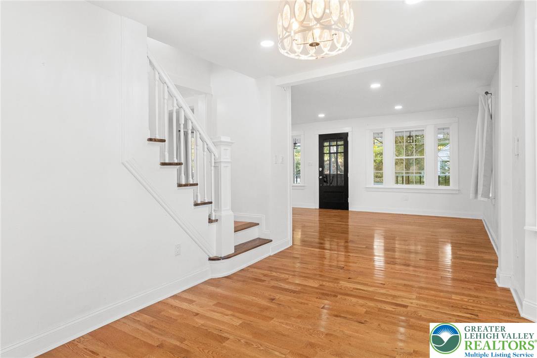 1439 Seidersville Road Bethlehem, PA 18015 - Photo 11 of 55 a view of an empty room with wooden floor and stairs