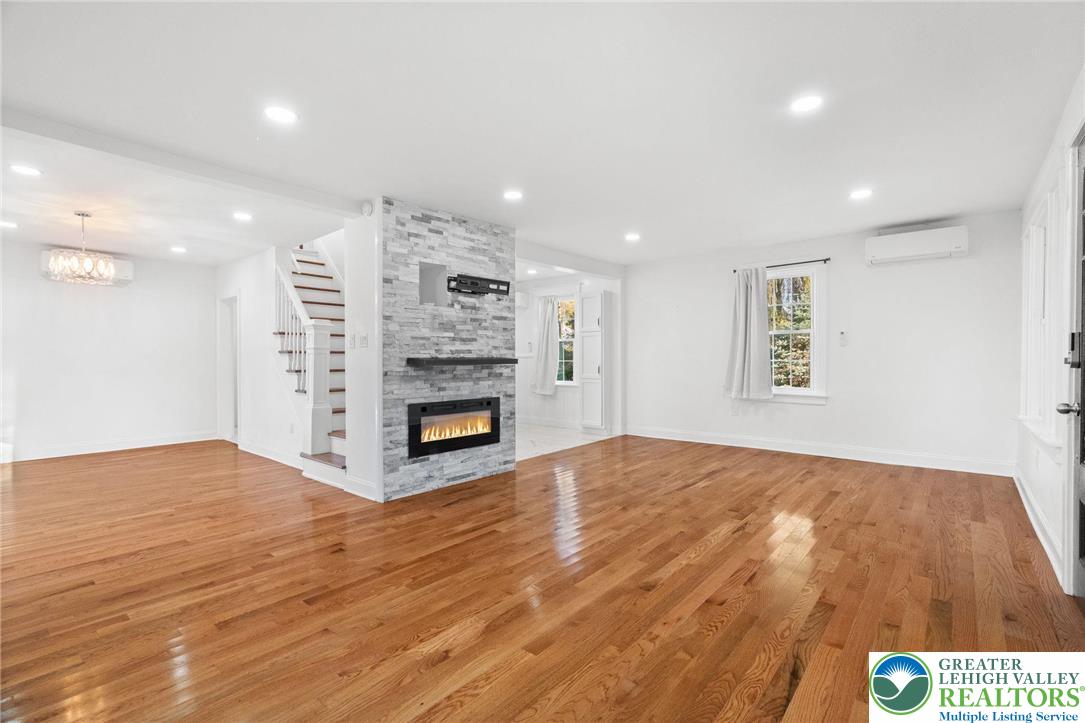 1439 Seidersville Road Bethlehem, PA 18015 - Photo 15 of 55 a view of an empty room with a fireplace and wooden floor