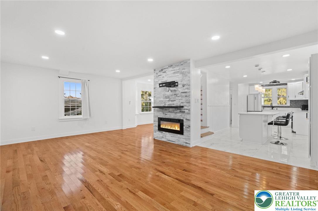 1439 Seidersville Road Bethlehem, PA 18015 - Photo 17 of 55 a view of an empty room with a fireplace and wooden floor