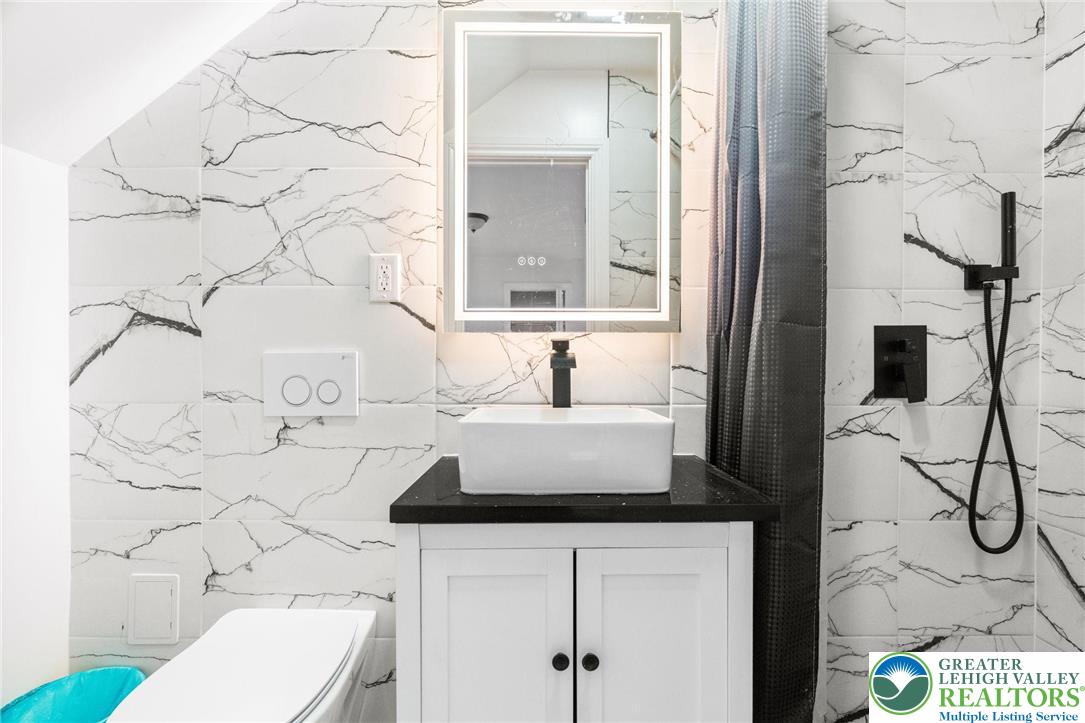 1439 Seidersville Road Bethlehem, PA 18015 - Photo 27 of 55 a bathroom with a sink toilet and mirror