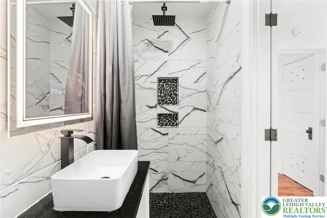 a bathroom with a sink and a mirror