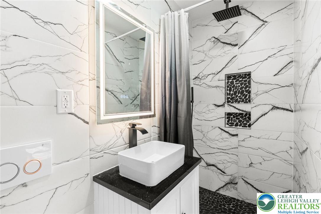 1439 Seidersville Road Bethlehem, PA 18015 - Photo 30 of 55 a bathroom with a sink and a mirror