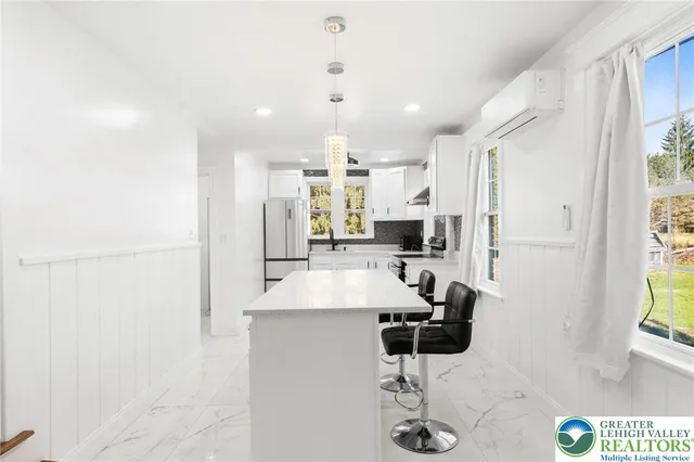 a kitchen with refrigerator and window