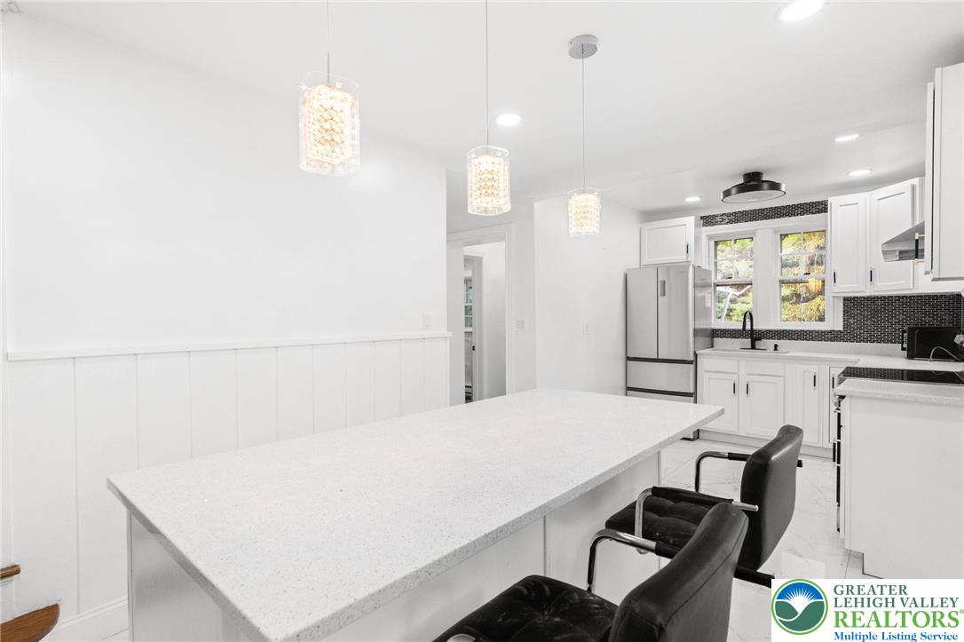 1439 Seidersville Road Bethlehem, PA 18015 - Photo 7 of 55 a kitchen with kitchen island a stove and white cabinets