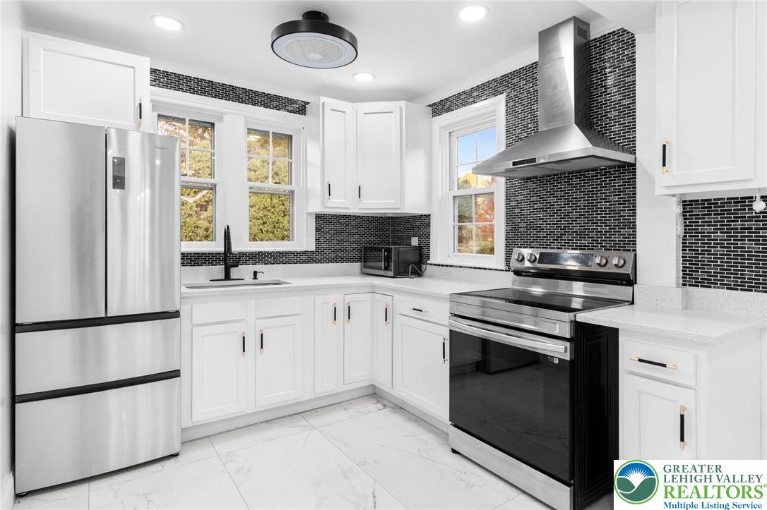 1439 Seidersville Road Bethlehem, PA 18015 - Photo 8 of 55 a kitchen with stainless steel appliances granite countertop a stove a sink and a refrigerator