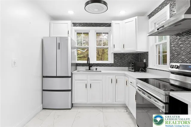 a kitchen with a refrigerator sink and cabinets