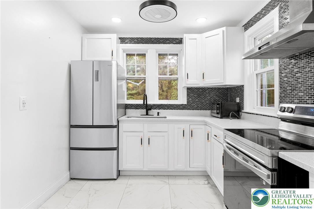 1439 Seidersville Road Bethlehem, PA 18015 - Photo 9 of 55 a kitchen with a refrigerator sink and cabinets