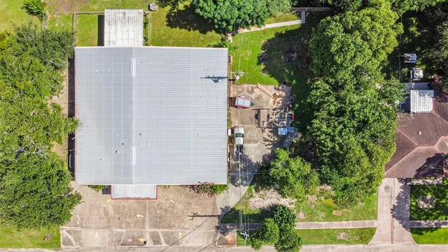 an aerial view of a house with a yard and garden