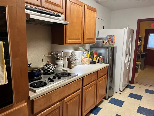 a kitchen with stainless steel appliances a stove a microwave and a refrigerator