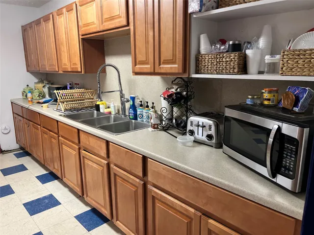 a kitchen with stainless steel appliances sink a microwave and cabinets