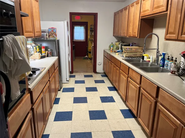 a kitchen with a sink a stove and cabinets