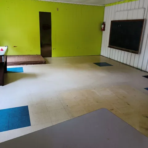a reading room with furniture and wooden floor