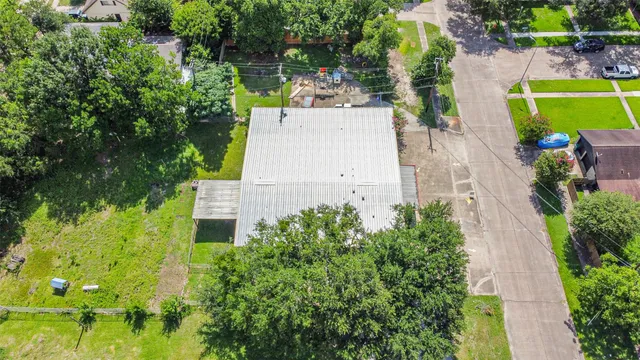 an aerial view of a house with a garden and swimming pool