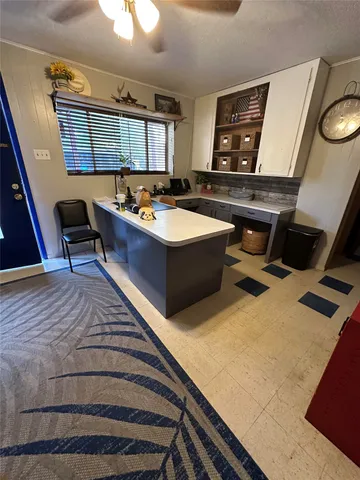 a living room with baby crib furniture and a window