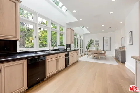 a large white kitchen with a large window