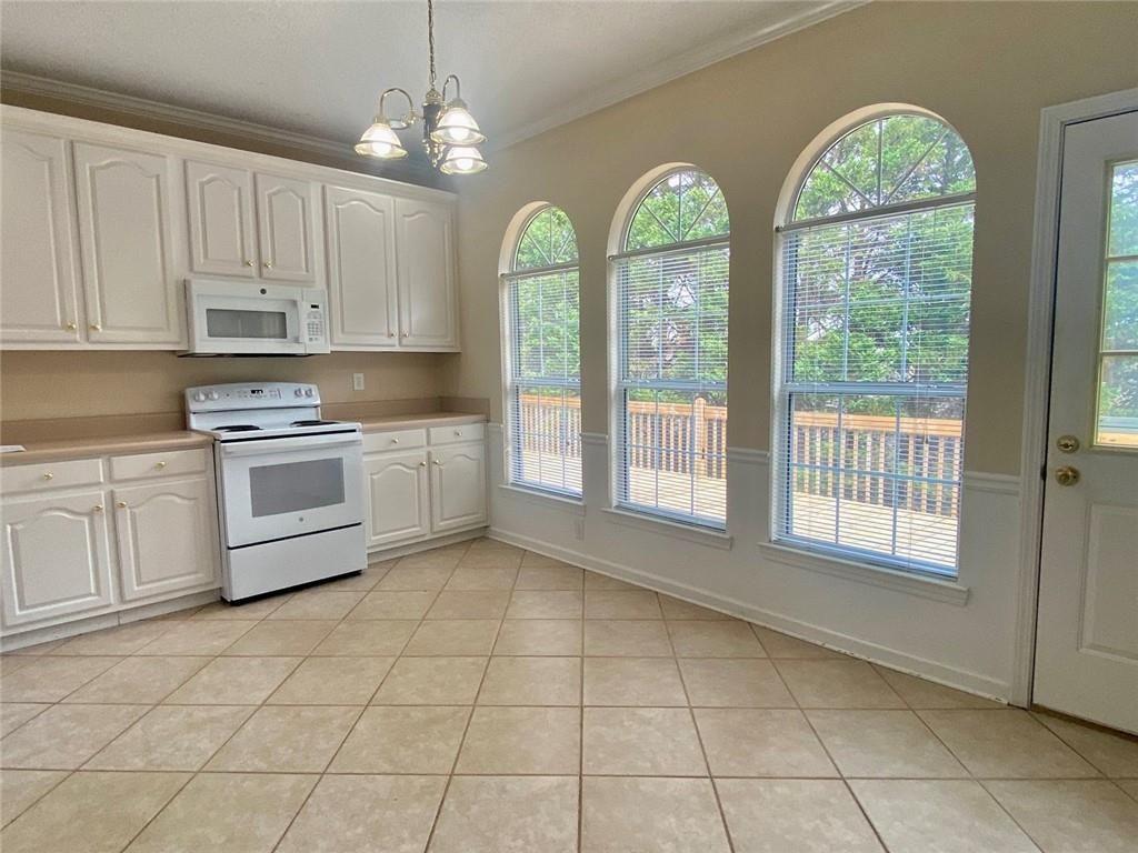 1698 Pin Oak Drive, Unit 129 Dalton, GA 30721 - Photo 12 of 37 a kitchen with a white cabinets and outdoor space