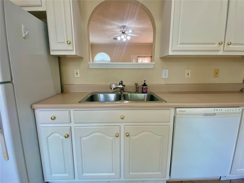 1698 Pin Oak Drive, Unit 129 Dalton, GA 30721 - Photo 14 of 37 a kitchen with white cabinets and a sink