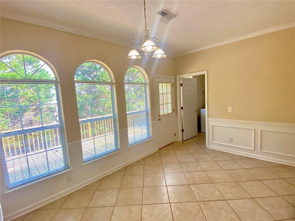 1698 Pin Oak Drive, Unit 129 Dalton, GA 30721 - Photo 15 of 37 a view of an empty room with chandelier fan and fire place