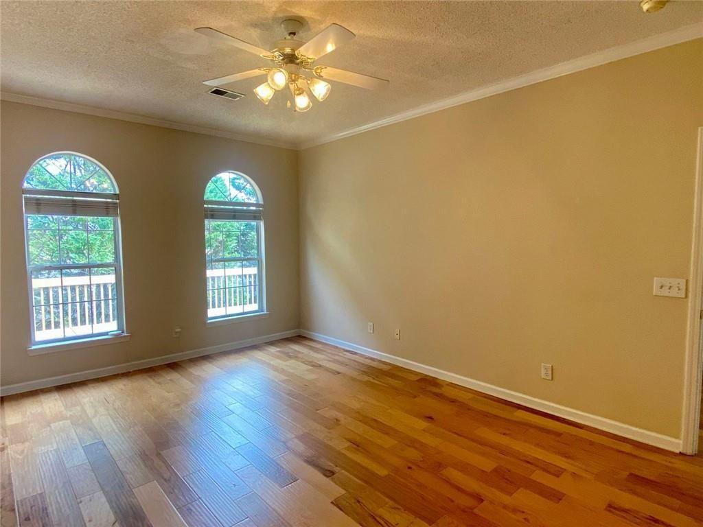 1698 Pin Oak Drive, Unit 129 Dalton, GA 30721 - Photo 19 of 37 a view of an empty room with a window and wooden floor
