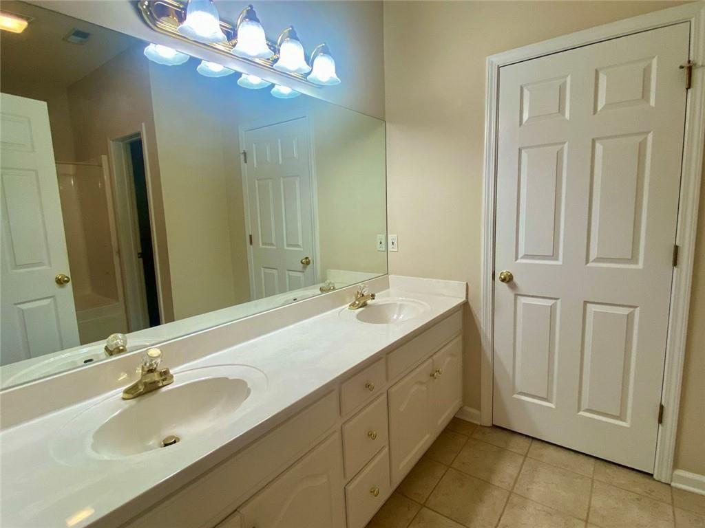 1698 Pin Oak Drive, Unit 129 Dalton, GA 30721 - Photo 21 of 37 a bathroom with a double vanity sink and a mirror
