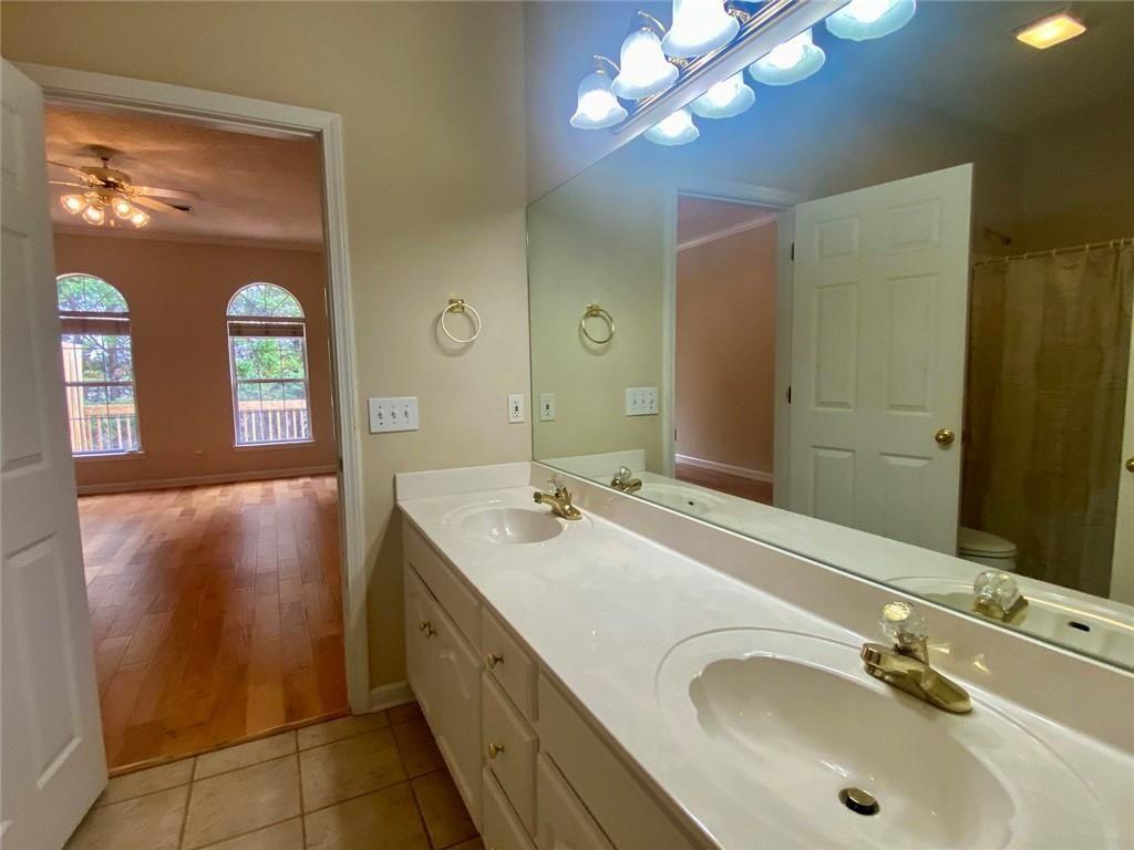 1698 Pin Oak Drive, Unit 129 Dalton, GA 30721 - Photo 22 of 37 a bathroom with a double vanity sink and a mirror