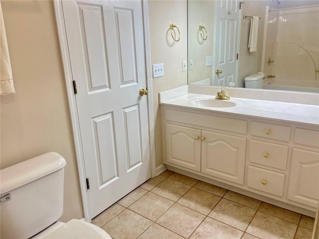 1698 Pin Oak Drive, Unit 129 Dalton, GA 30721 - Photo 24 of 37 a bathroom with a sink a toilet and a mirror