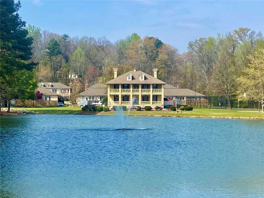1698 Pin Oak Drive, Unit 129 Dalton, GA 30721 - Photo 35 of 37 a view of yard with swimming pool and trees in the background
