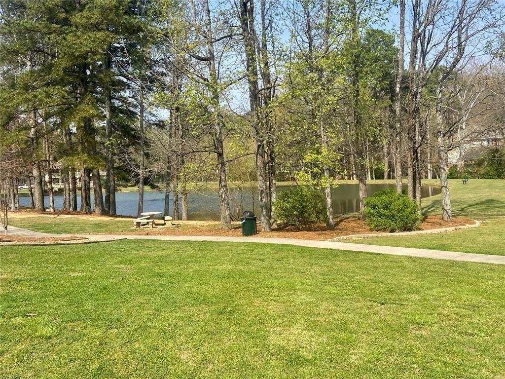 1698 Pin Oak Drive, Unit 129 Dalton, GA 30721 - Photo 36 of 37 a view of a swimming pool with a big yard and large trees