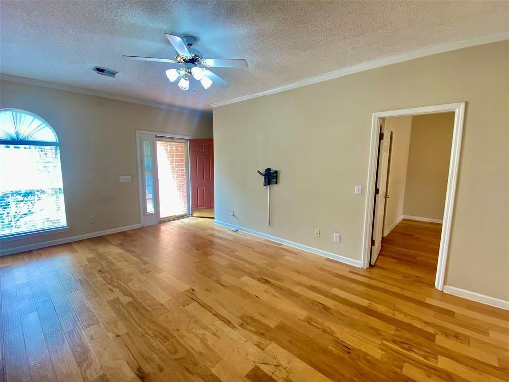 1698 Pin Oak Drive, Unit 129 Dalton, GA 30721 - Photo 8 of 37 a view of an empty room with window and wooden floor