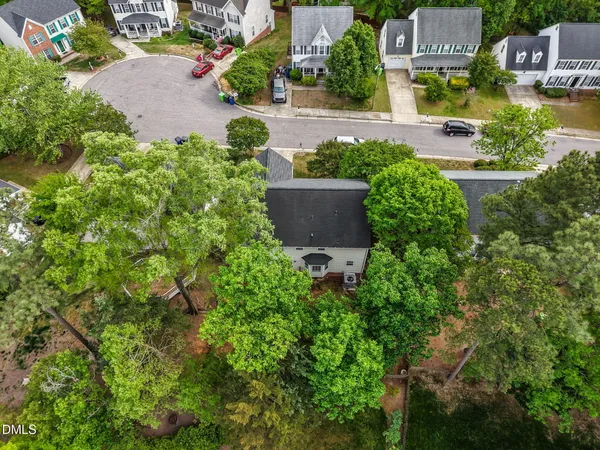 an aerial view of a house with a yard and garden