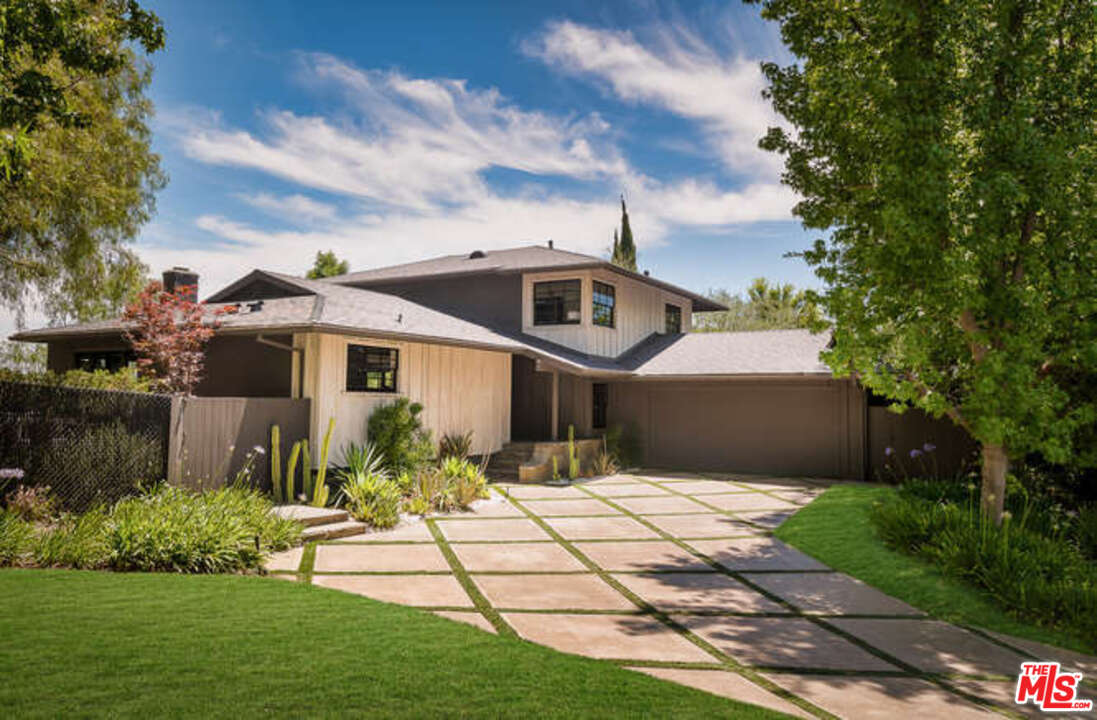1374 Stradella Road Los Angeles, CA 90077 - Photo 1 of 47 a front view of a house with garden