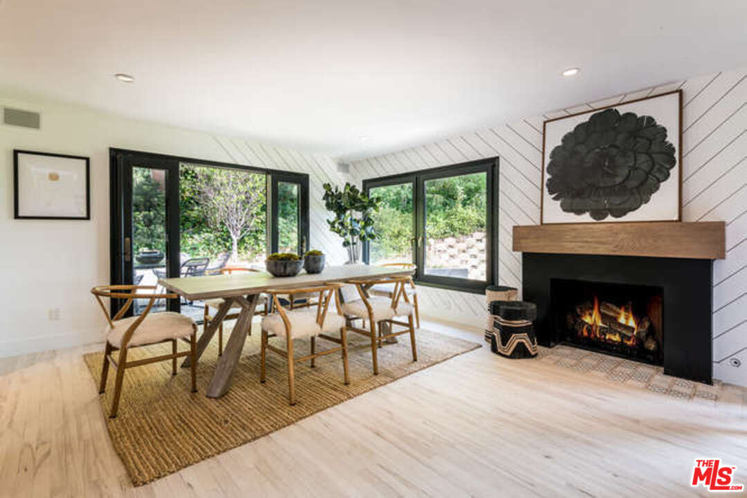 1374 Stradella Road Los Angeles, CA 90077 - Photo 13 of 47 a living room with furniture a large window and a fireplace