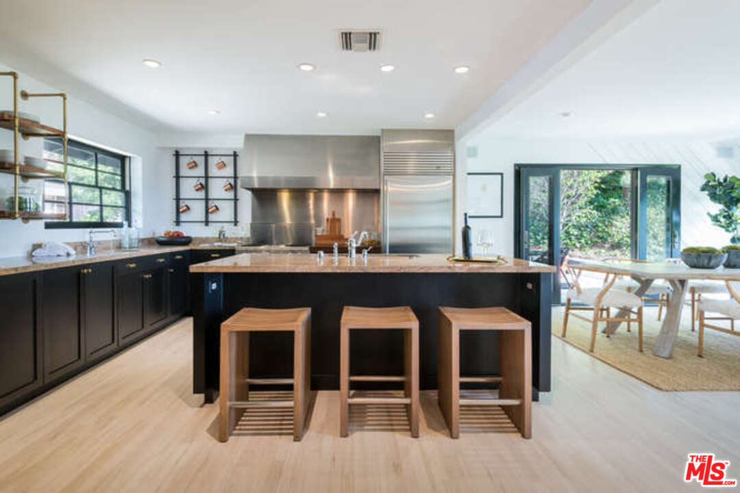 1374 Stradella Road Los Angeles, CA 90077 - Photo 14 of 47 a kitchen with a sink and chairs