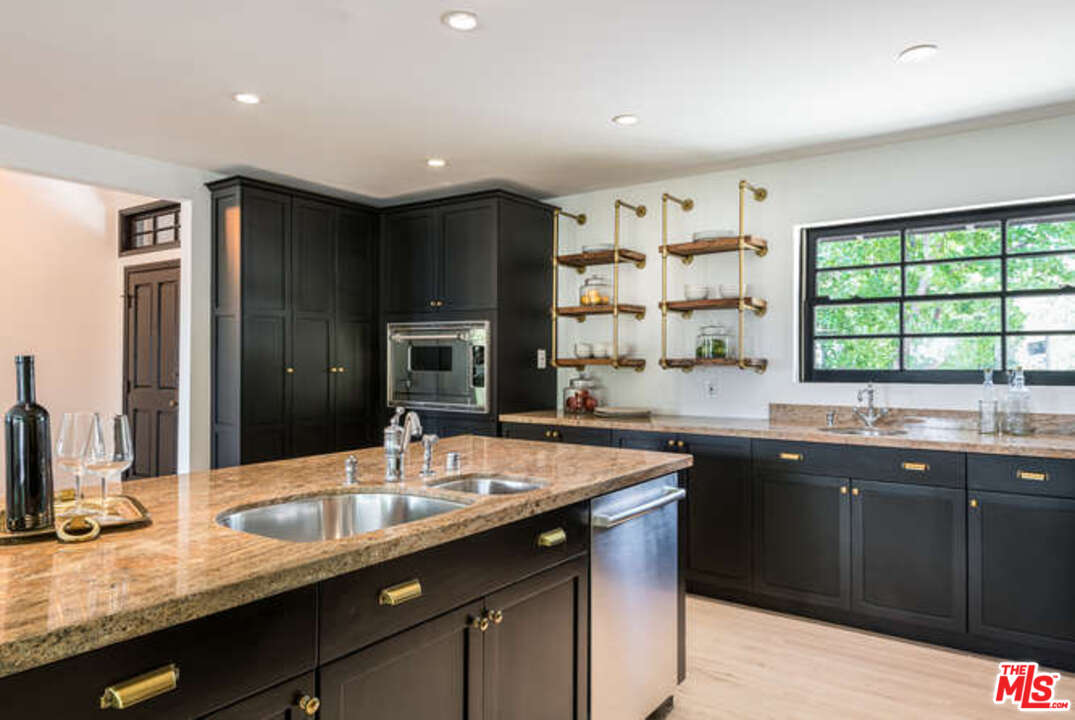1374 Stradella Road Los Angeles, CA 90077 - Photo 16 of 47 a kitchen with lots of counter space sink and large window