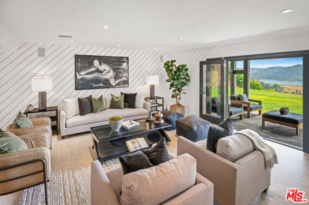 1374 Stradella Road Los Angeles, CA 90077 - Photo 18 of 47 a living room with furniture and a large window