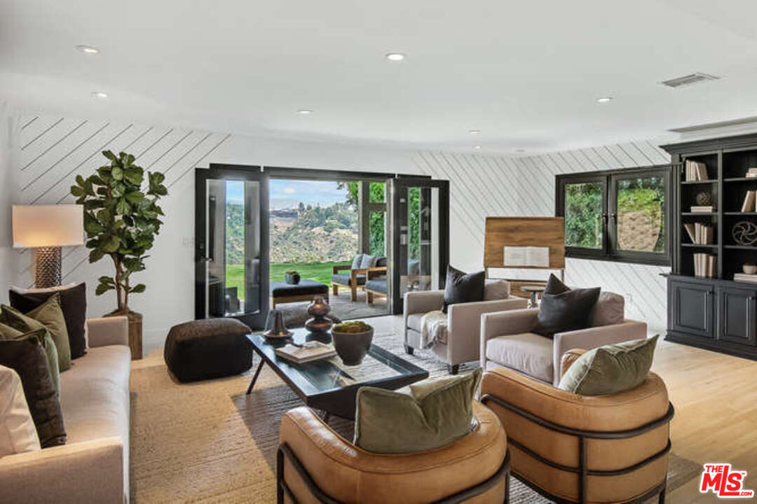 1374 Stradella Road Los Angeles, CA 90077 - Photo 19 of 47 a living room with furniture and a large window