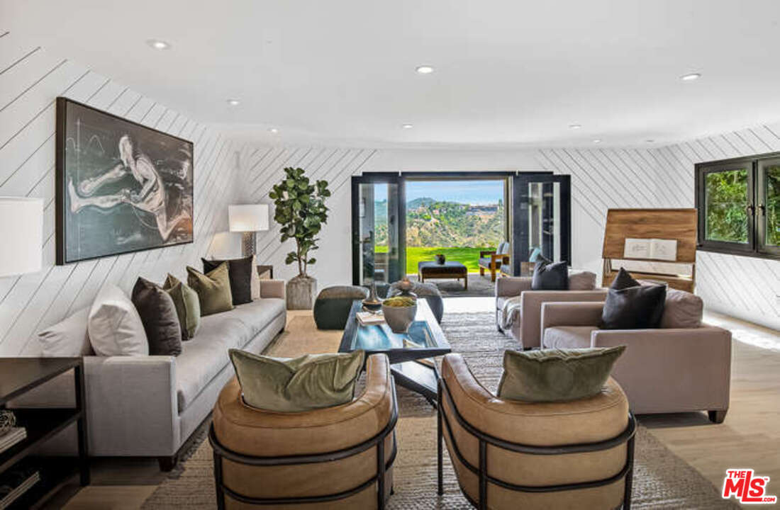 1374 Stradella Road Los Angeles, CA 90077 - Photo 20 of 47 a living room with furniture and a large window