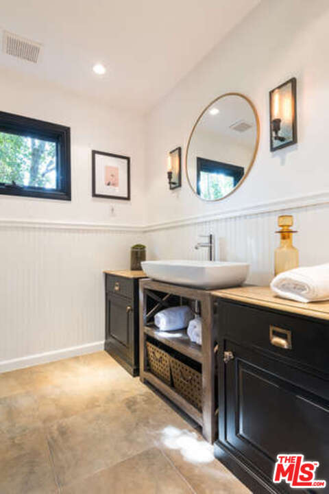 1374 Stradella Road Los Angeles, CA 90077 - Photo 23 of 47 a room with a sink and a mirror