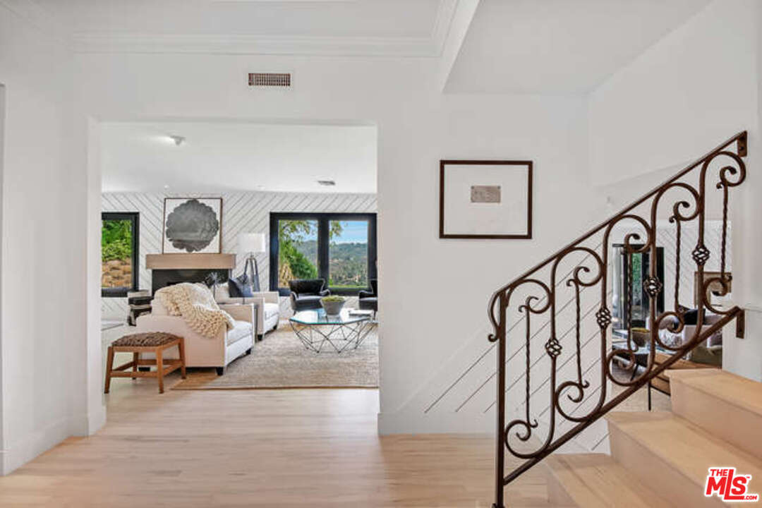 1374 Stradella Road Los Angeles, CA 90077 - Photo 24 of 47 a living room with furniture and wooden floor