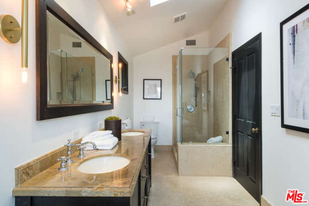 1374 Stradella Road Los Angeles, CA 90077 - Photo 31 of 47 a bathroom with a sink and a mirror