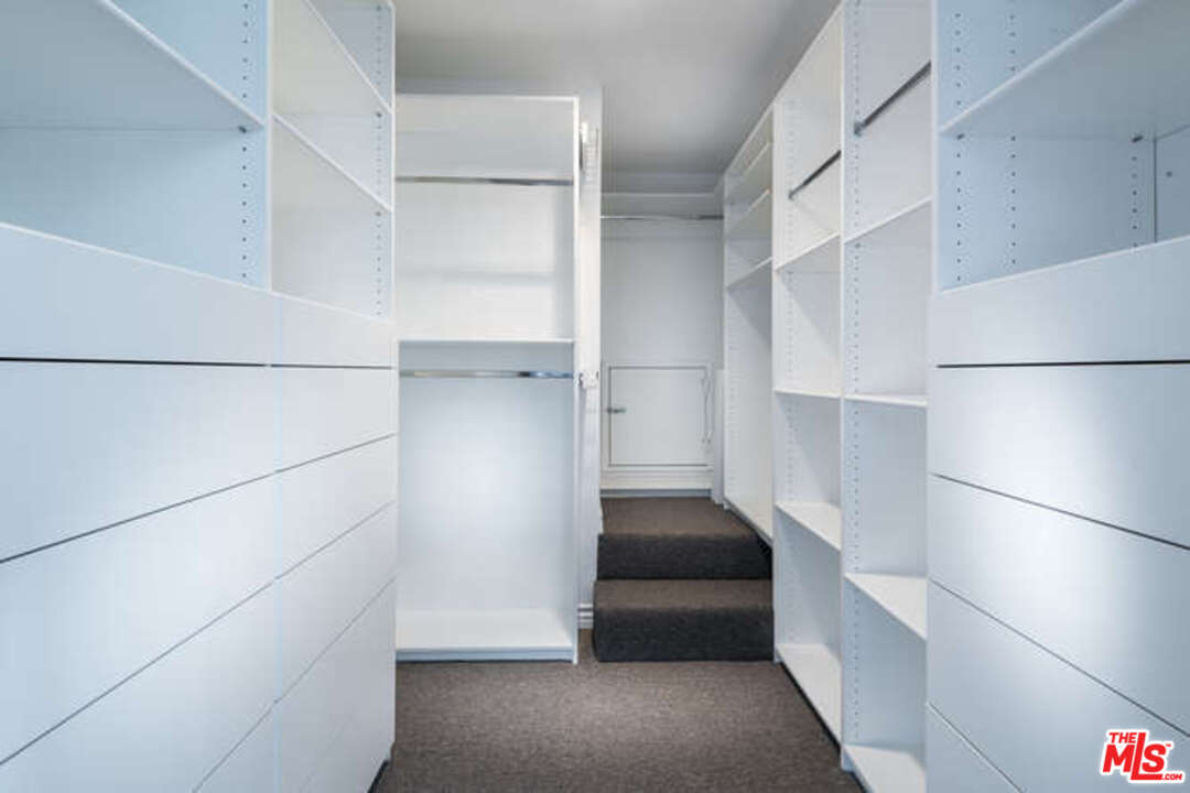 1374 Stradella Road Los Angeles, CA 90077 - Photo 33 of 47 a view of walk in closet with empty racks