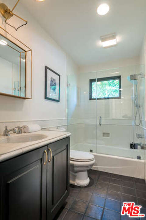 1374 Stradella Road Los Angeles, CA 90077 - Photo 36 of 47 a bathroom with a sink and a mirror