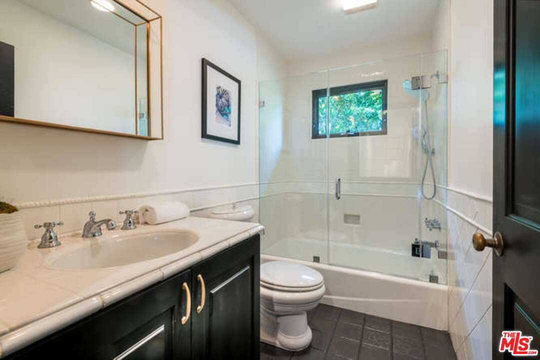 1374 Stradella Road Los Angeles, CA 90077 - Photo 37 of 47 a bathroom with a sink a toilet and shower
